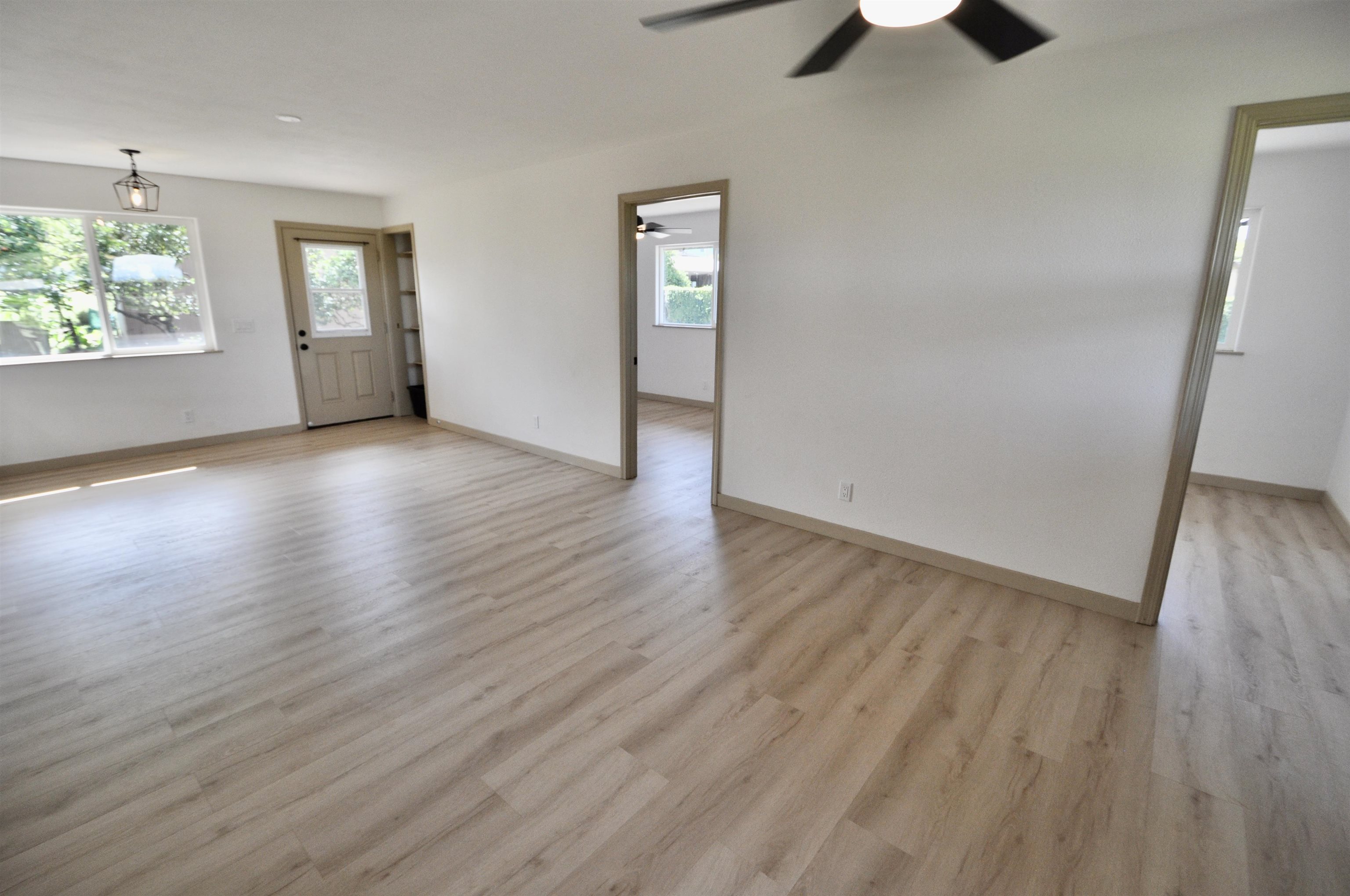 2835 Kaupakalua Road Haiku, HI 96708 - Photo 5 of 31 an empty room with wooden floor and windows