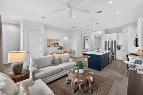 a living room with furniture and a wooden floor