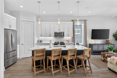 a large kitchen with a table and chairs