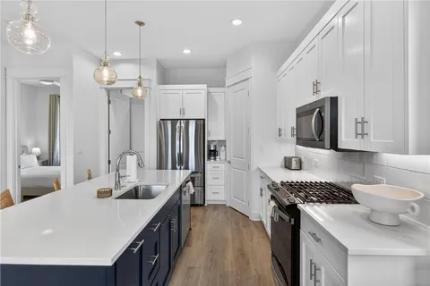 a kitchen with stainless steel appliances a sink stove and refrigerator