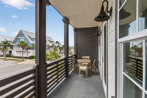 a view of a balcony with yard and patio