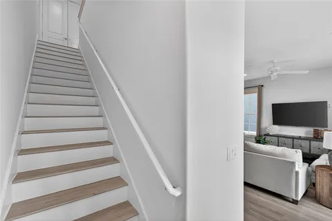 a view of a livingroom with furniture and staircase