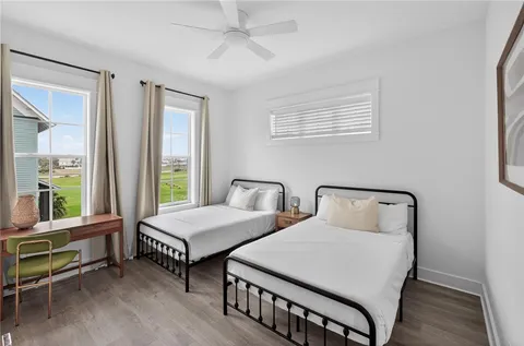 a bedroom with two beds and a window