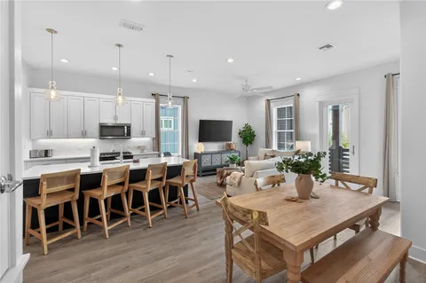 a large kitchen with a table and chairs