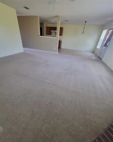 a view of a big room with closet and windows