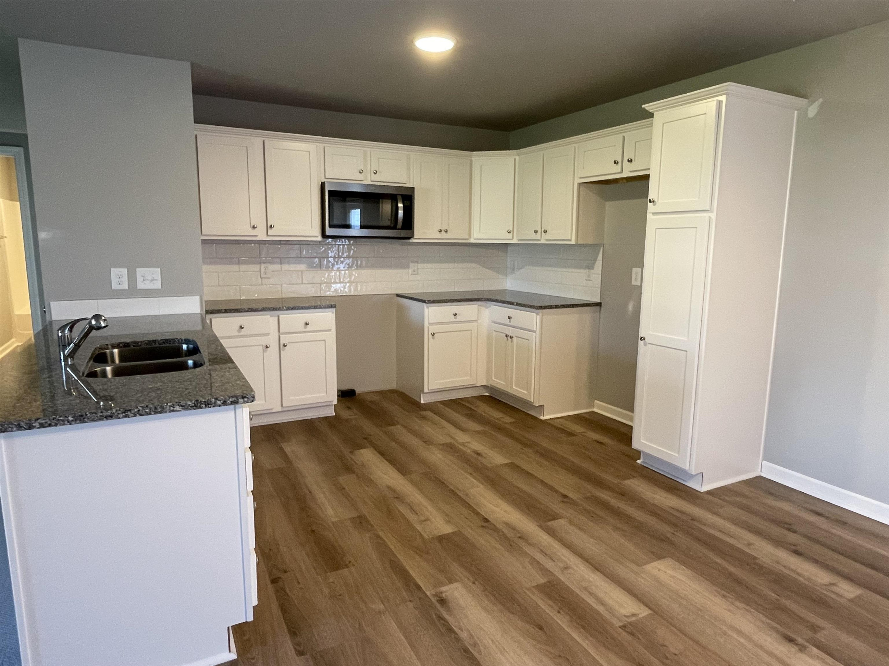 496 Roberts Road Willow Spring, NC 27592 - Photo 4 of 15 a kitchen with granite countertop a sink a stove and refrigerator