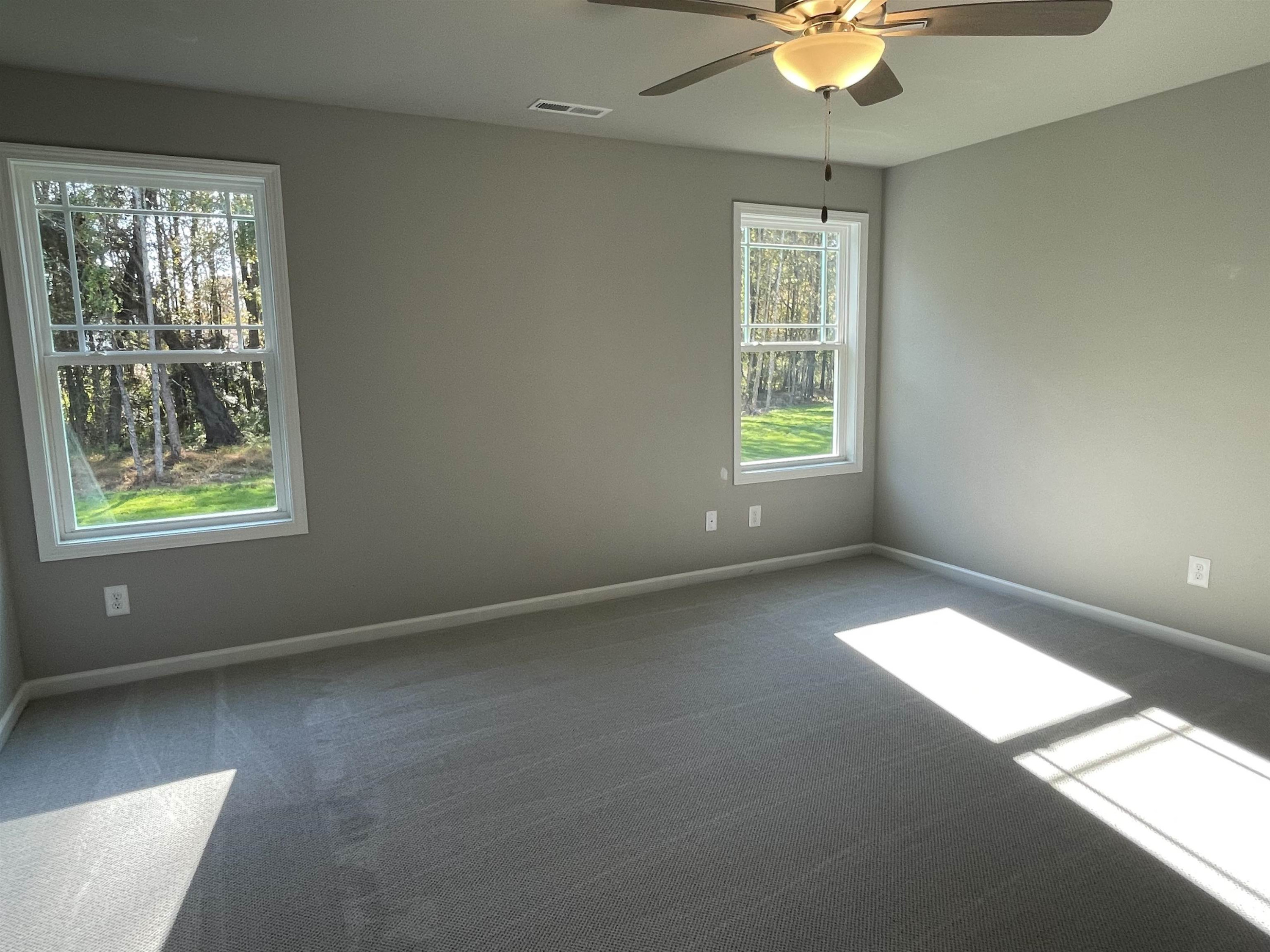 496 Roberts Road Willow Spring, NC 27592 - Photo 6 of 15 a view of an empty room with windows