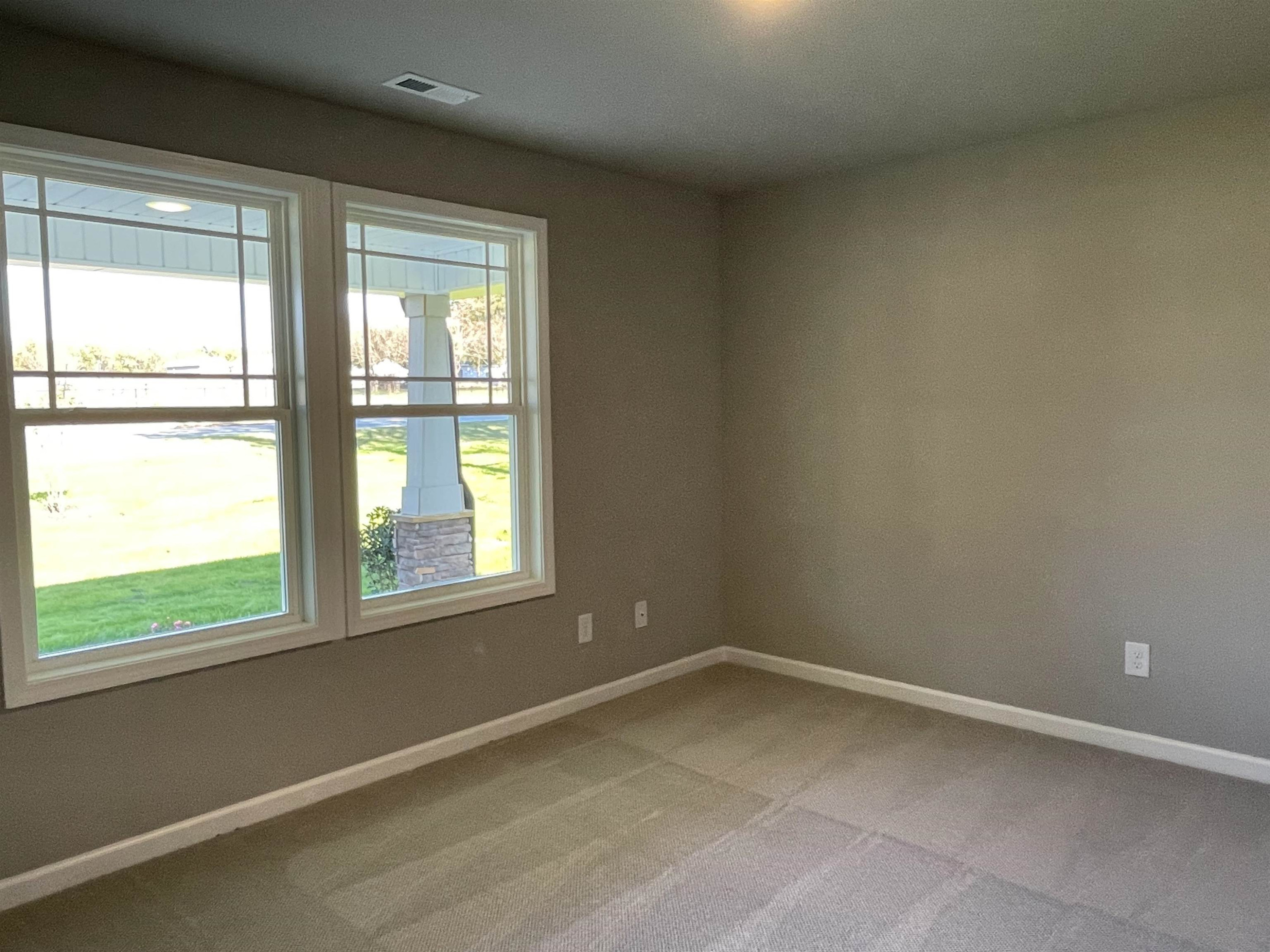 496 Roberts Road Willow Spring, NC 27592 - Photo 10 of 15 an empty room with a window