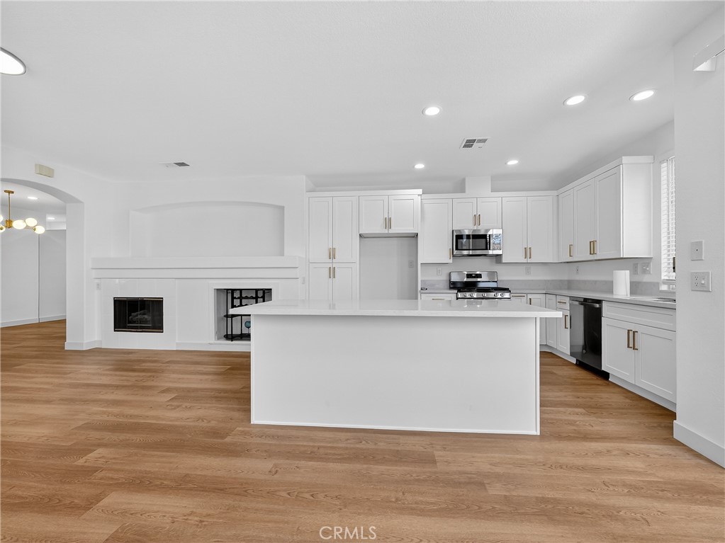 1436 Riviera Avenue Banning, CA 92220 - Photo 1 of 43 a large kitchen with cabinets and wooden floor