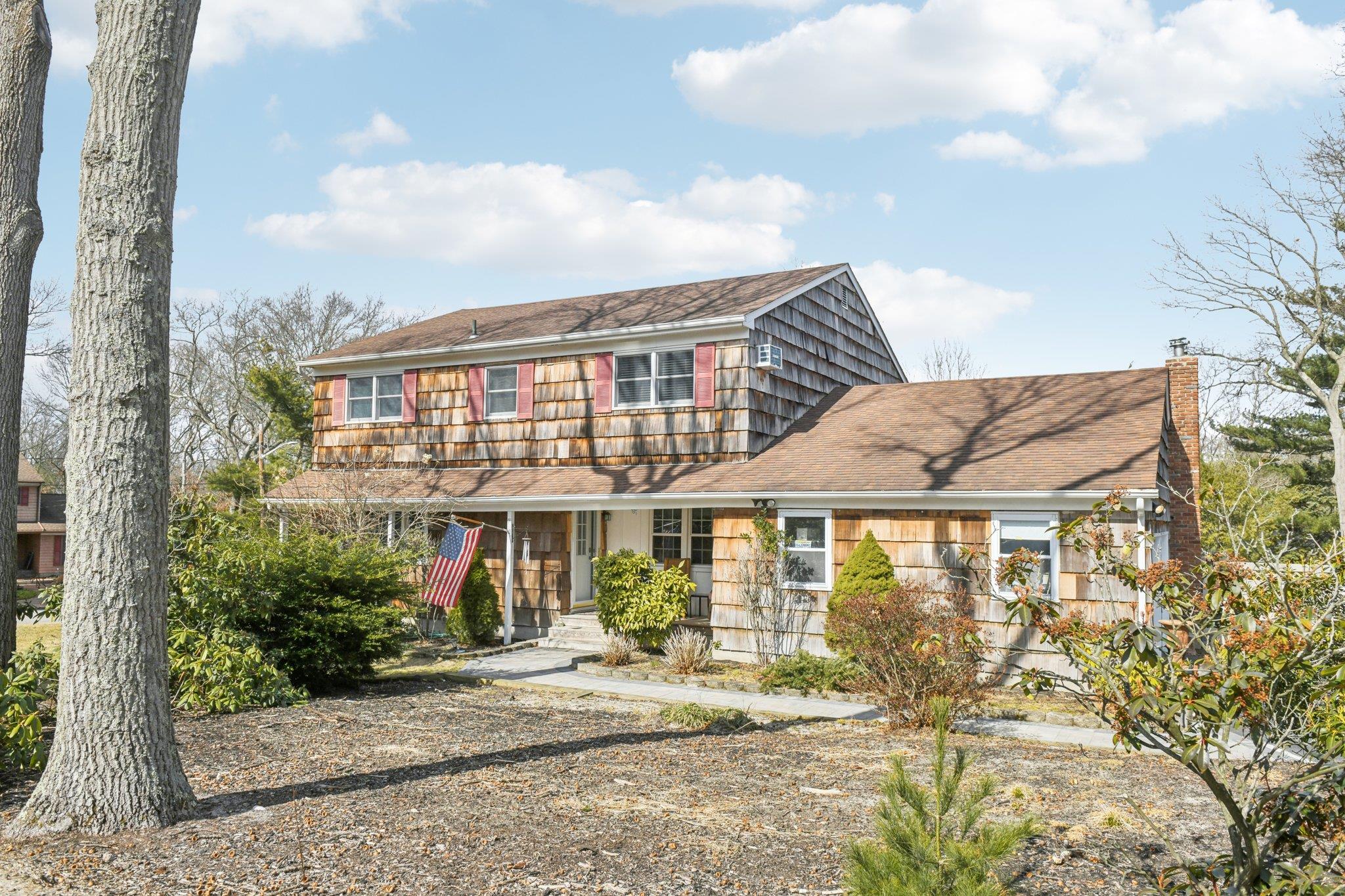 25 Fox Road East Setauket, NY 11733 - Photo 1 of 1 View of front facade with a chimney and a porch