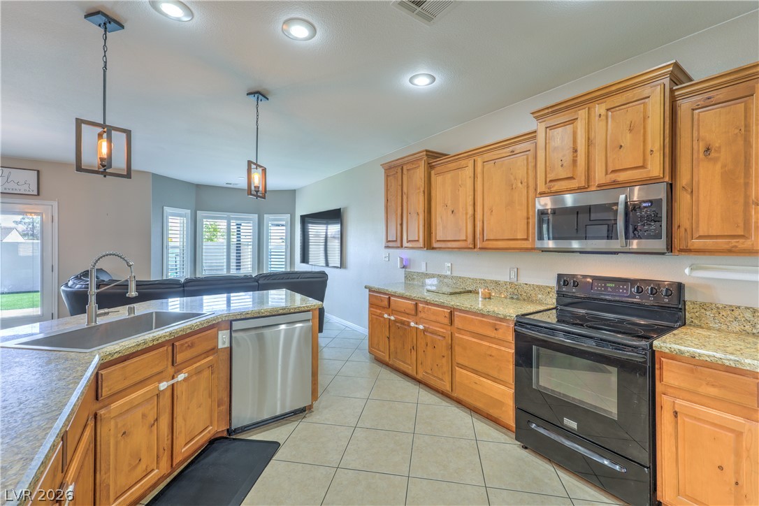 580 Lillian Condie Road Overton, NV 89040 - Photo 7 of 37 A well-appointed kitchen features ample cabinetry, granite countertops, and modern appliances.