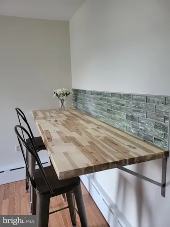 a view of a workspace with furniture and a flat screen tv