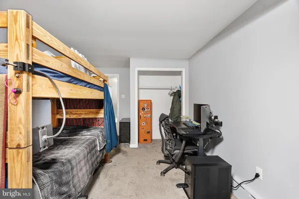 a bedroom with a bed and a chair