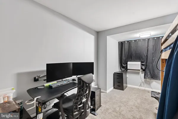 a bedroom with a bed and a tv