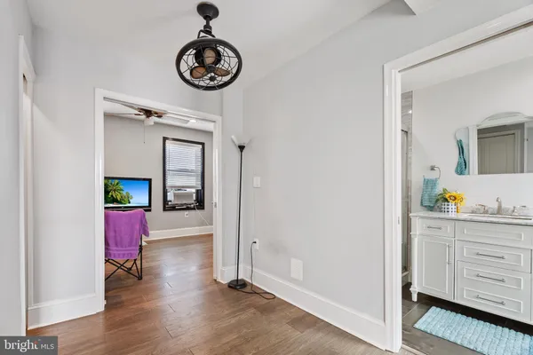 a bathroom with a granite countertop sink mirror vanity and toilet