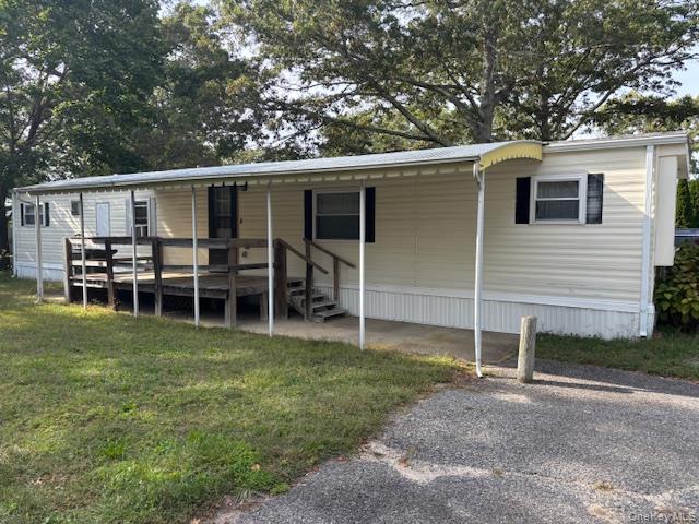 a view of a backyard with table and chairs and barbeque grill with wooden fence
