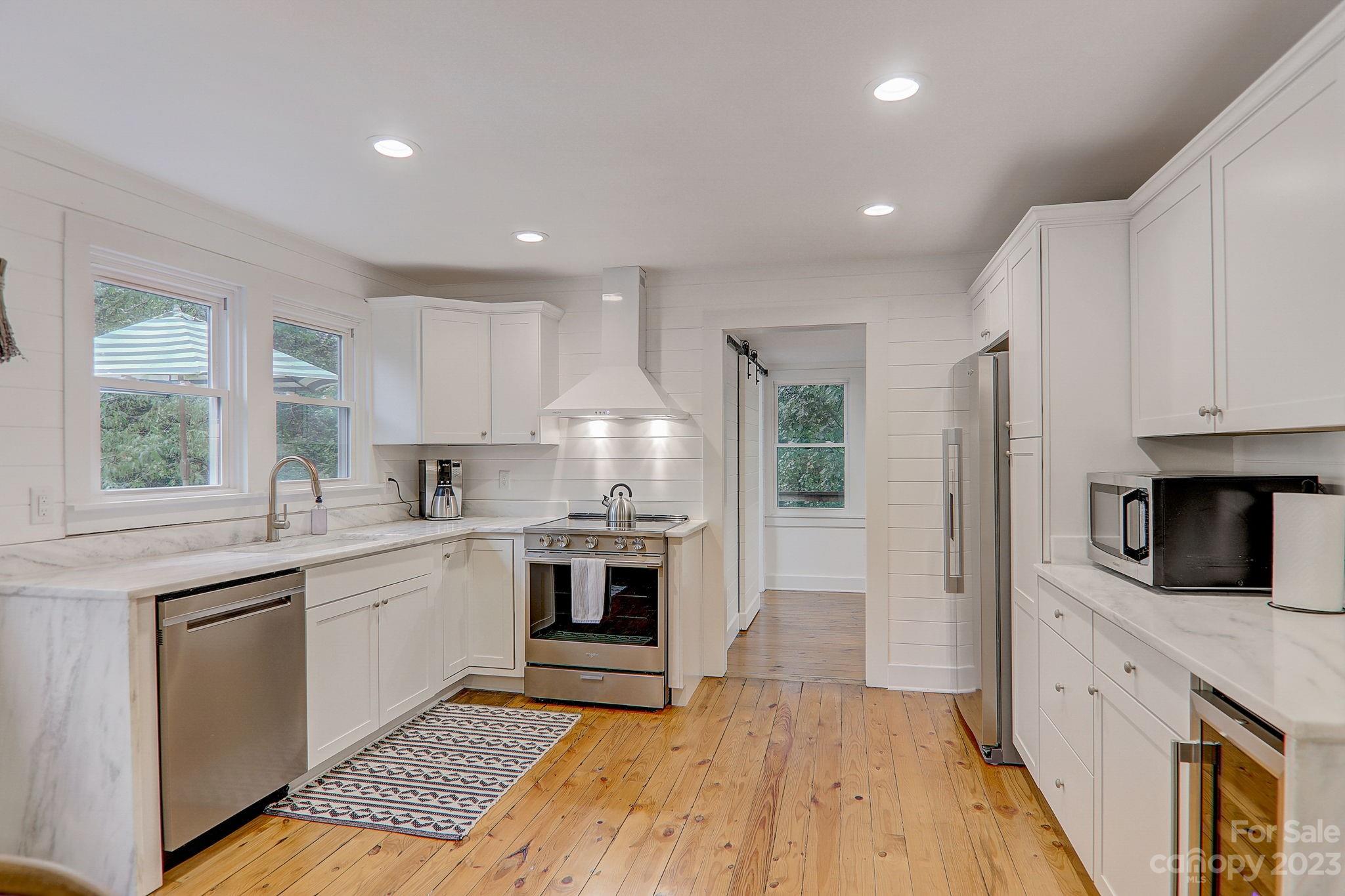 290 Upper Brush Creek Road Fletcher, NC 28732 - Photo 12 of 48 a kitchen with white cabinets and appliances