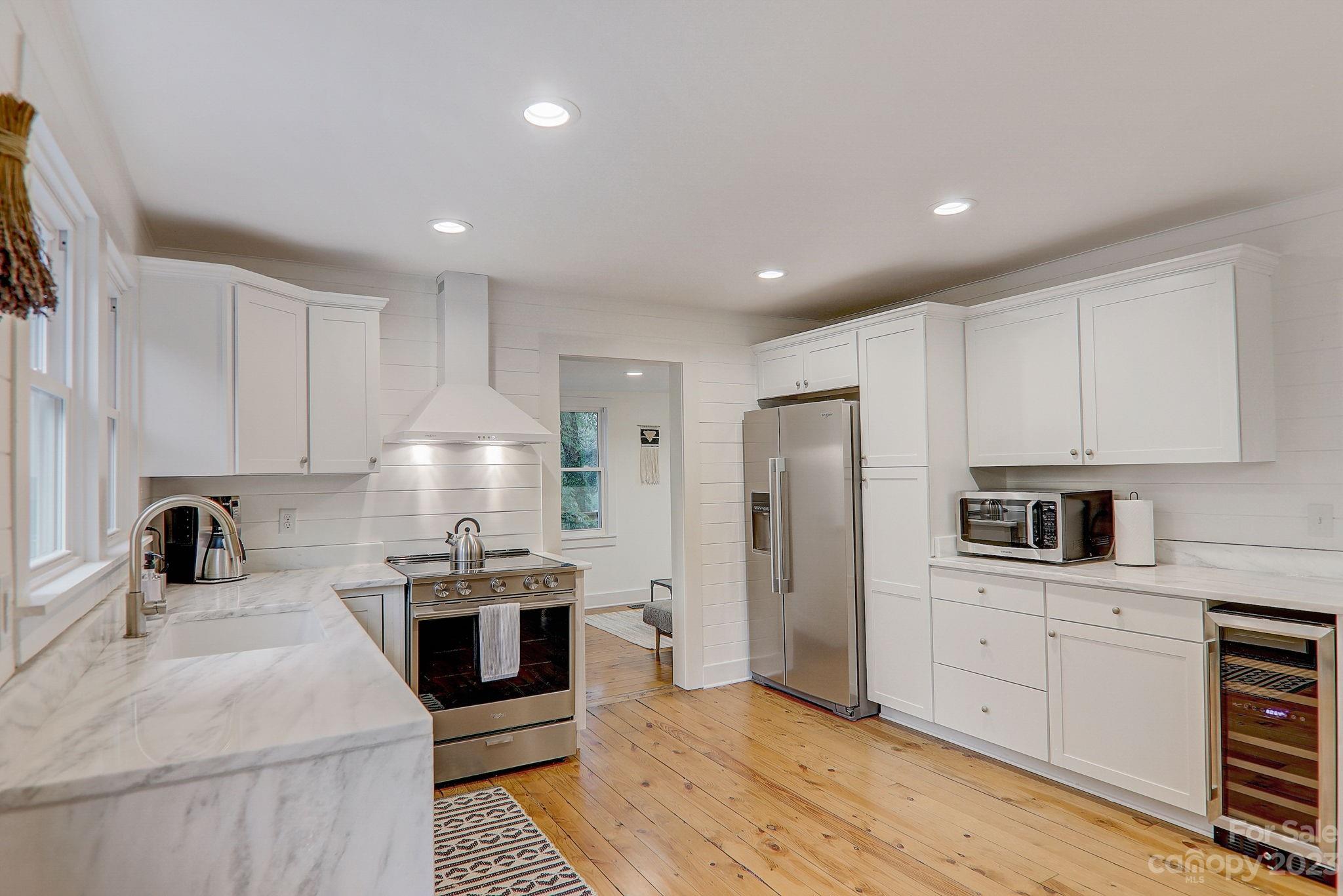 290 Upper Brush Creek Road Fletcher, NC 28732 - Photo 13 of 48 a kitchen with stainless steel appliances a refrigerator sink and stove top oven