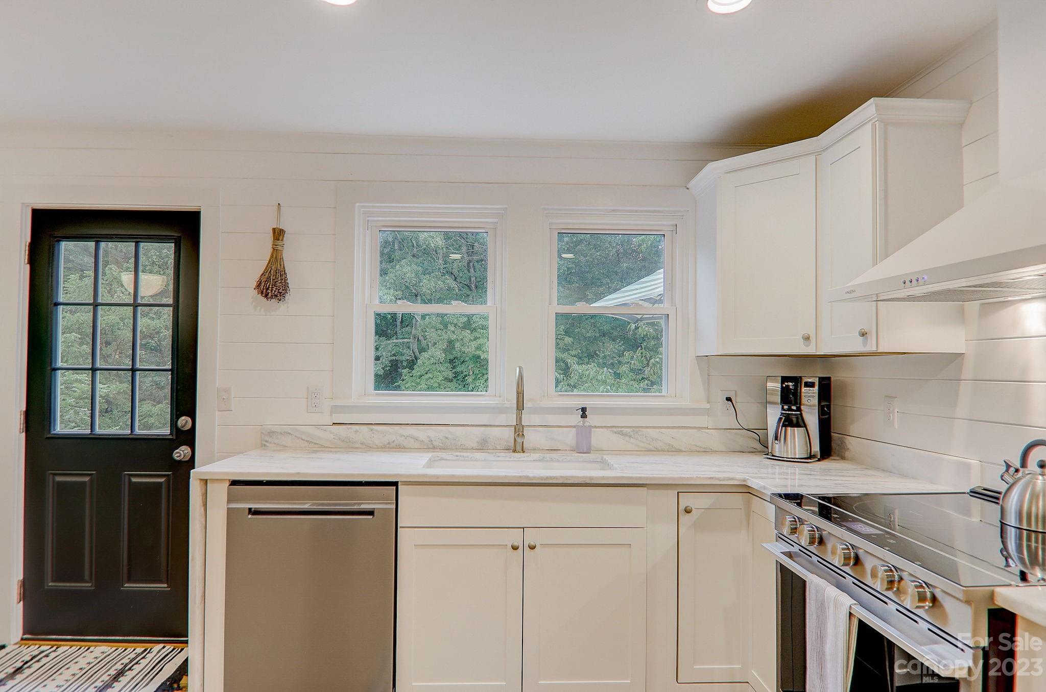 290 Upper Brush Creek Road Fletcher, NC 28732 - Photo 14 of 48 a kitchen with stainless steel appliances granite countertop a sink a stove and a refrigerator