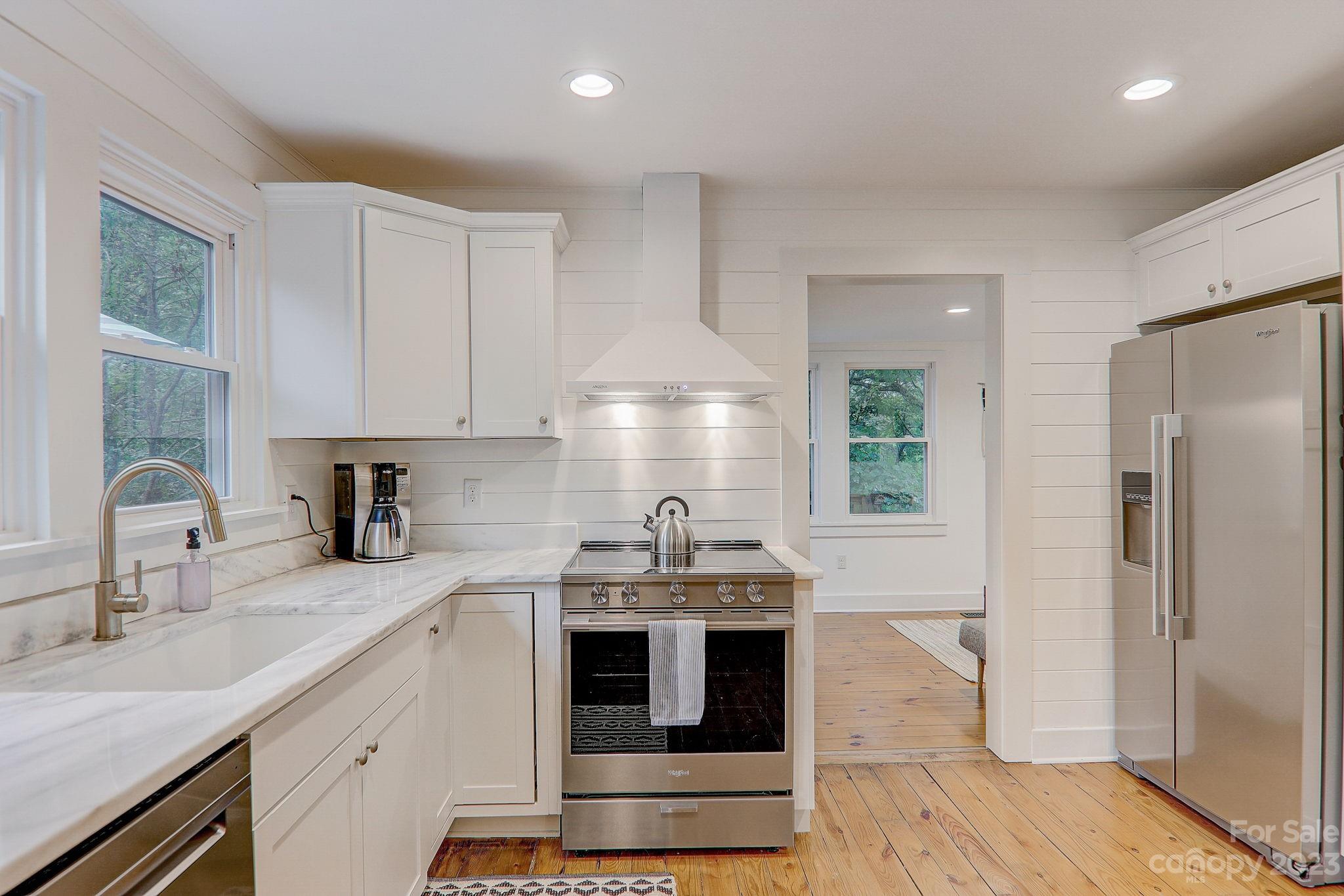 290 Upper Brush Creek Road Fletcher, NC 28732 - Photo 15 of 48 a kitchen with stainless steel appliances a stove a sink and a refrigerator