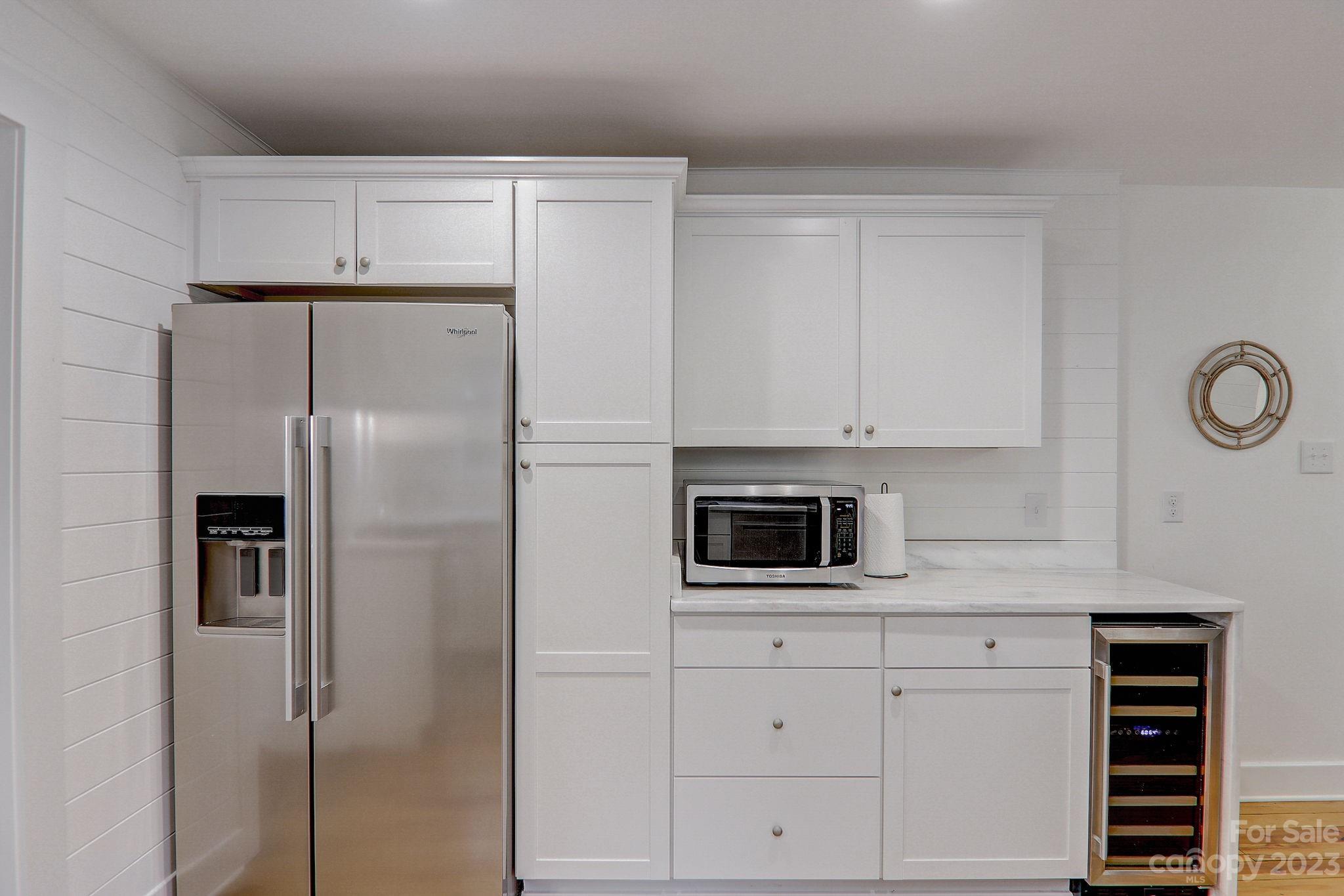 290 Upper Brush Creek Road Fletcher, NC 28732 - Photo 16 of 48 a kitchen with white cabinets and stainless steel appliances