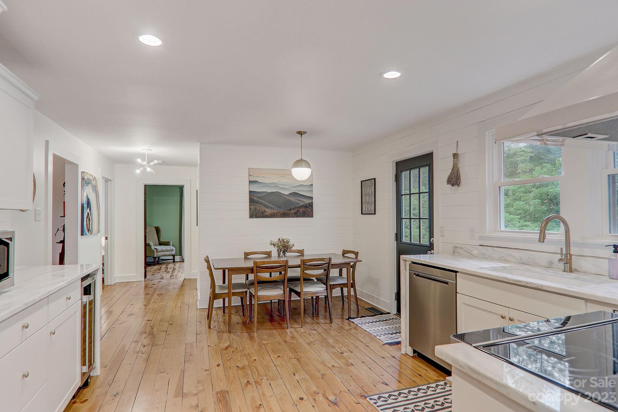 290 Upper Brush Creek Road Fletcher, NC 28732 - Photo 17 of 48 a view of a a dining room with furniture window and wooden floor