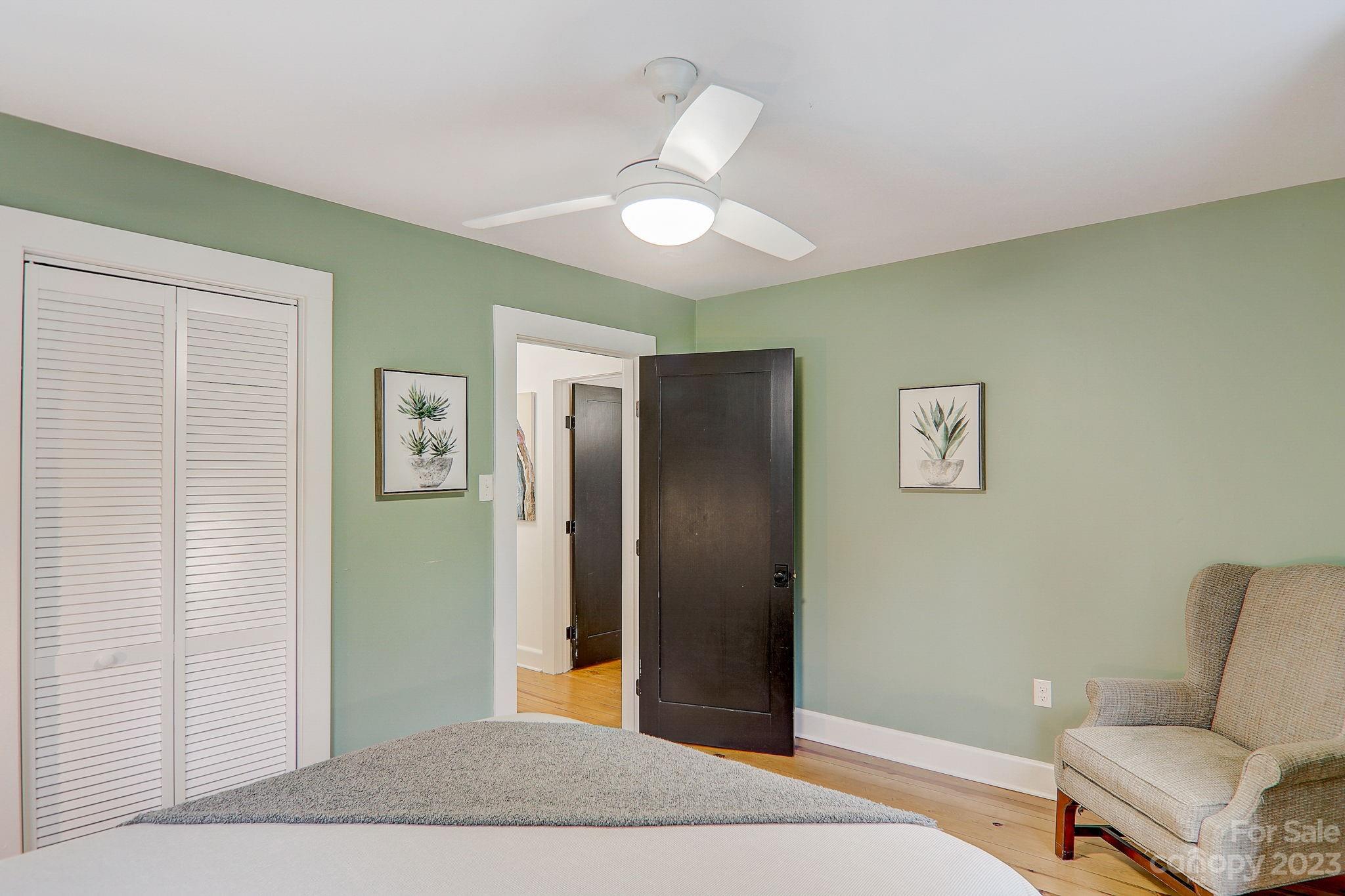 290 Upper Brush Creek Road Fletcher, NC 28732 - Photo 25 of 48 a bedroom with a bed and a chandelier