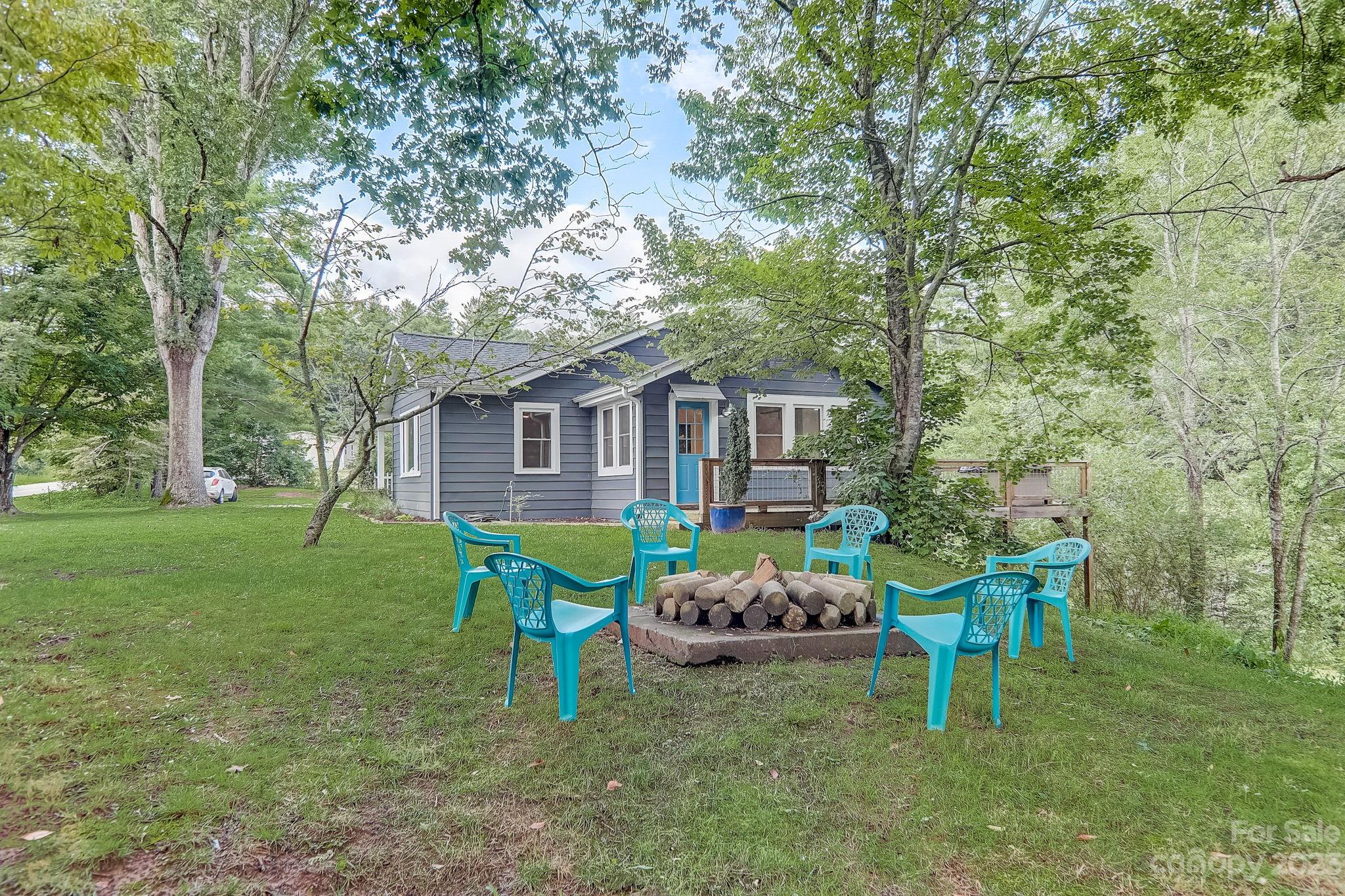 290 Upper Brush Creek Road Fletcher, NC 28732 - Photo 33 of 48 a porch with a table and chairs