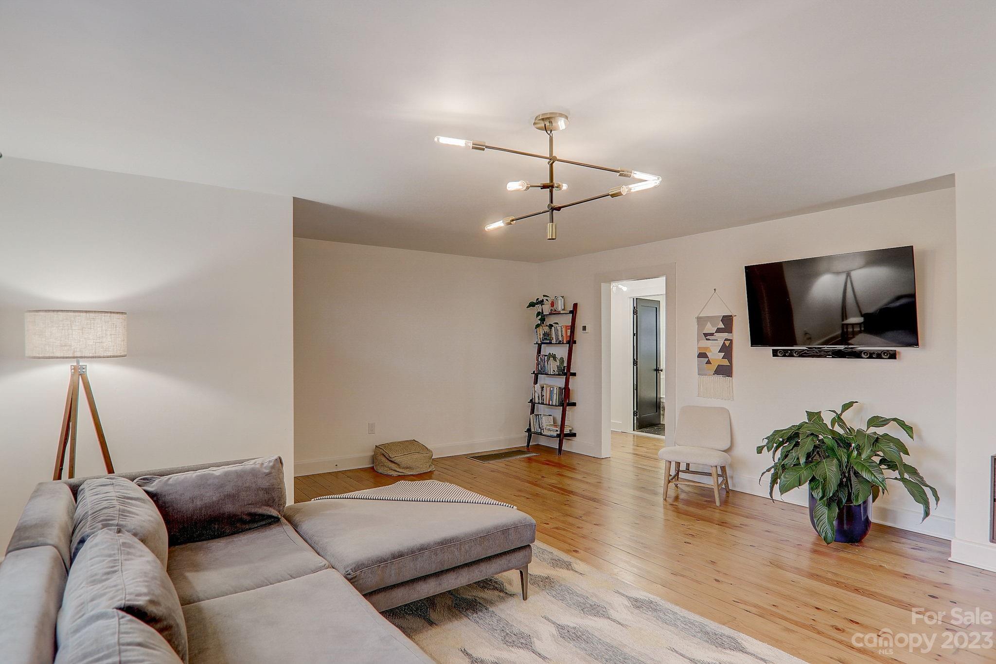 290 Upper Brush Creek Road Fletcher, NC 28732 - Photo 5 of 48 a living room with furniture and a flat screen tv