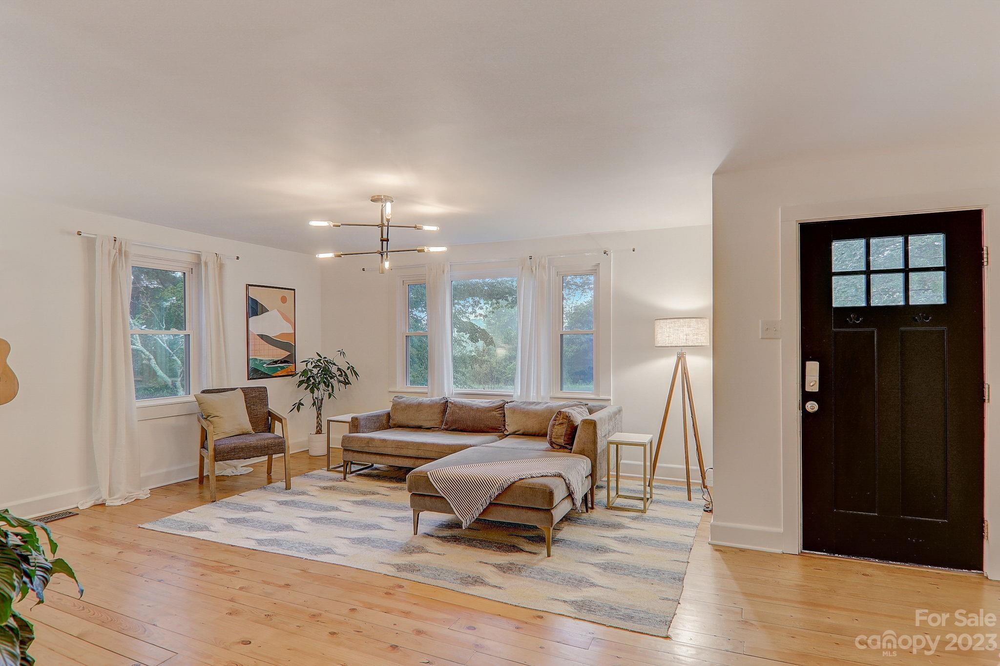 290 Upper Brush Creek Road Fletcher, NC 28732 - Photo 6 of 48 a living room with furniture and a chandelier