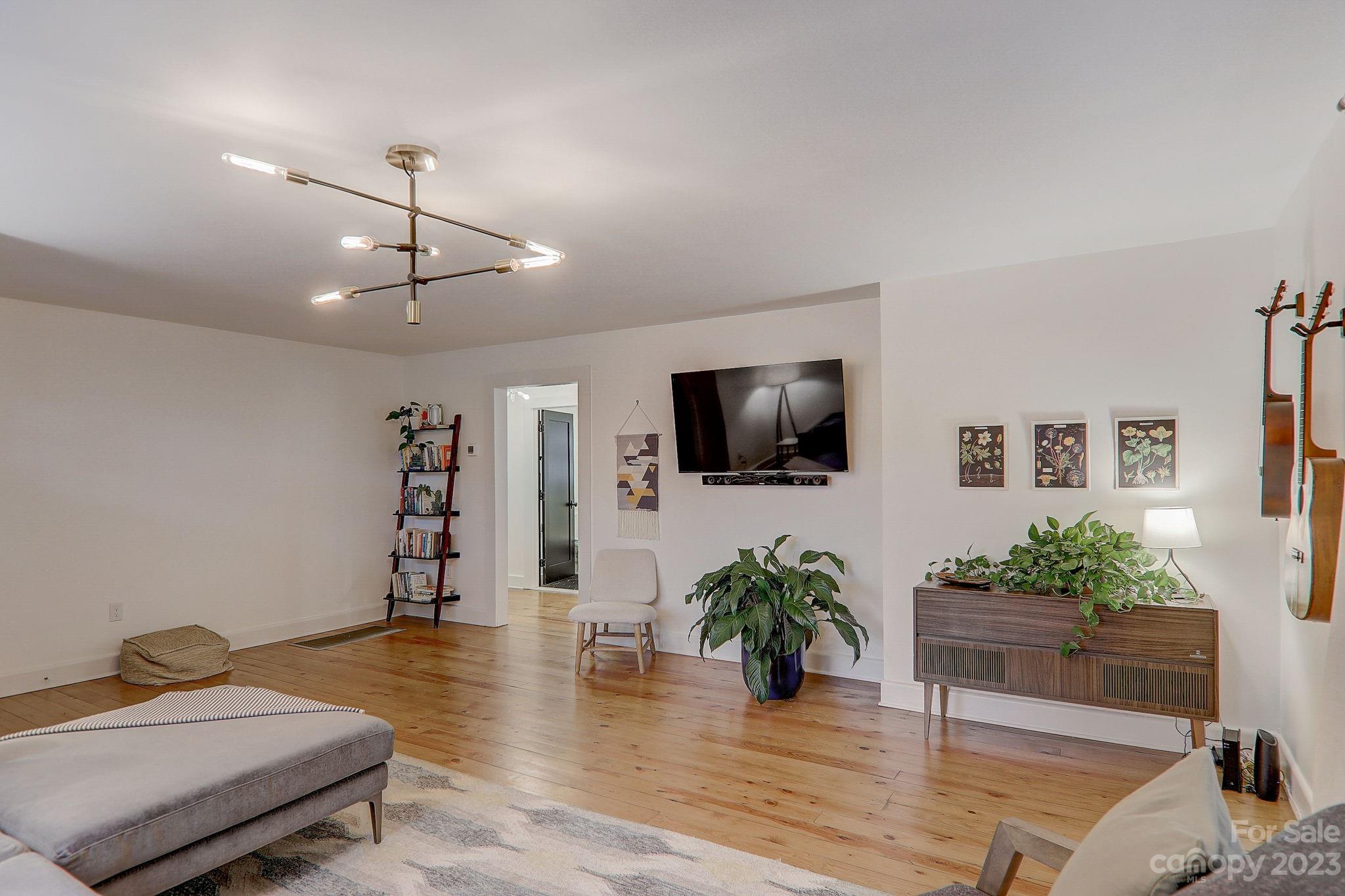 290 Upper Brush Creek Road Fletcher, NC 28732 - Photo 8 of 48 a living room with furniture and a flat screen tv