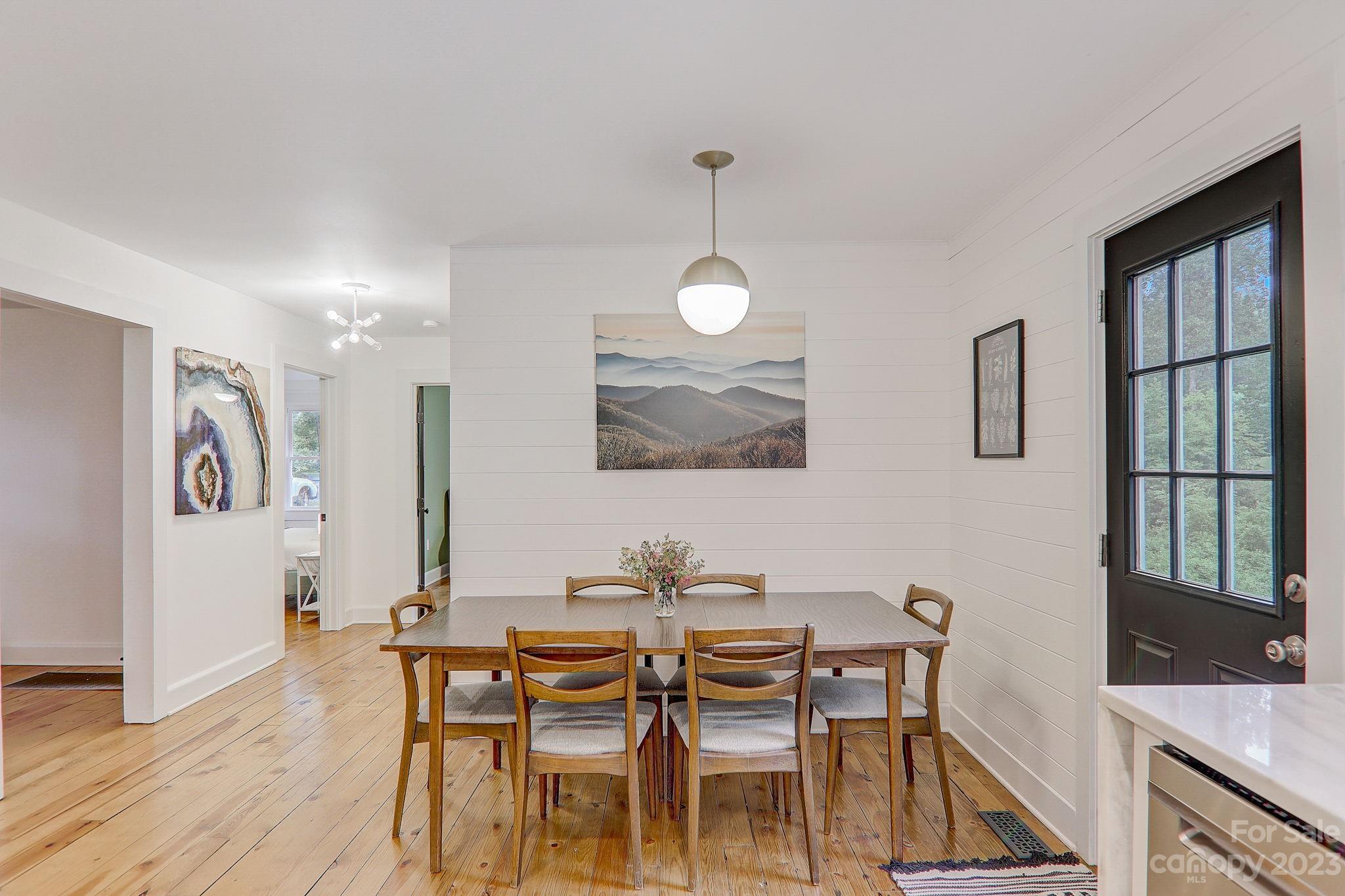 290 Upper Brush Creek Road Fletcher, NC 28732 - Photo 10 of 48 a view of a dining room with furniture and wooden floor