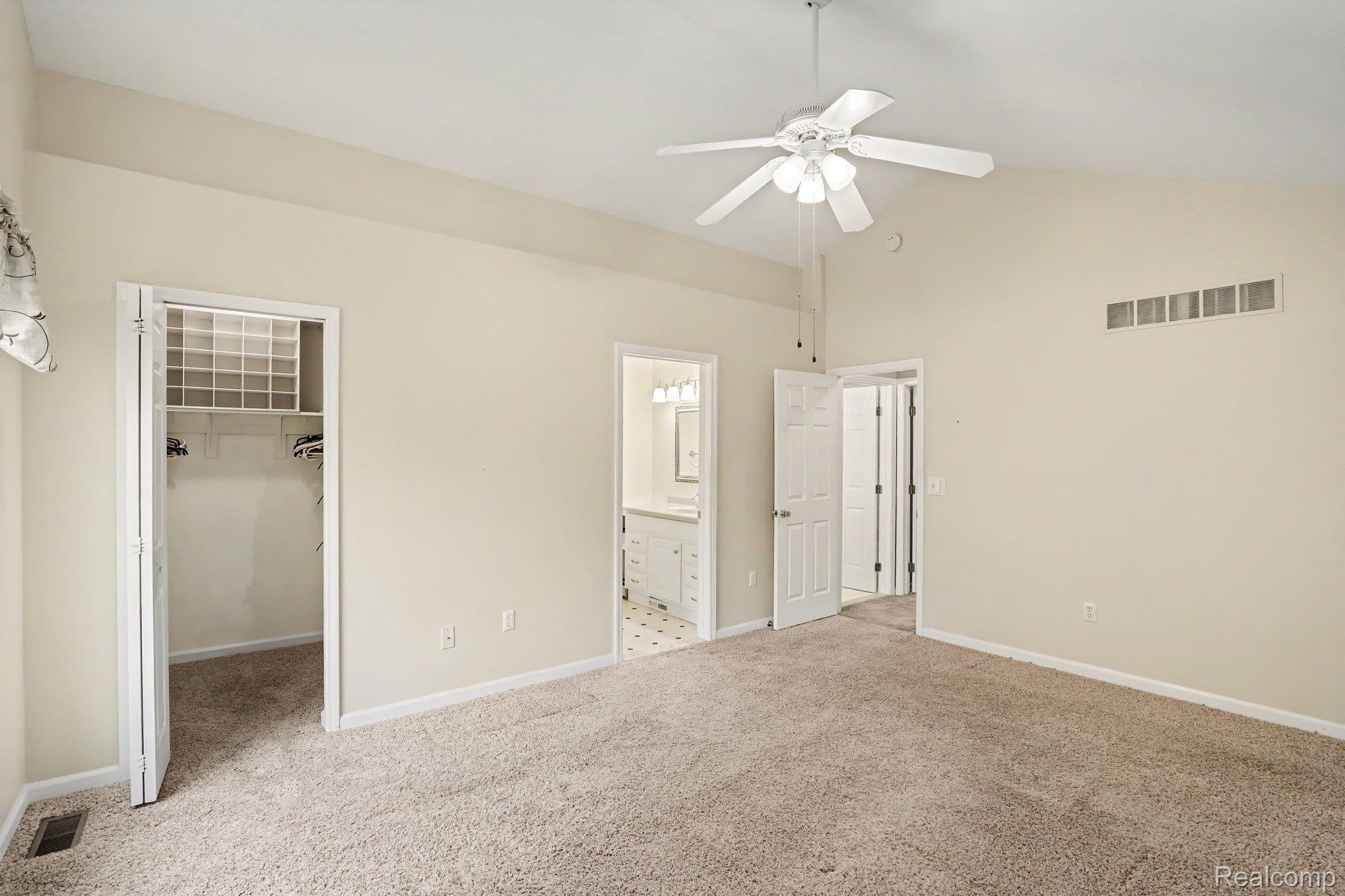 34917 Chickadee Ridge Richmond, MI 48062 - Photo 14 of 32 Vaulted ceiling, carpet flooring, ceiling fan with integrated lighting, bi-fold closet doors, and integrated closet shelving