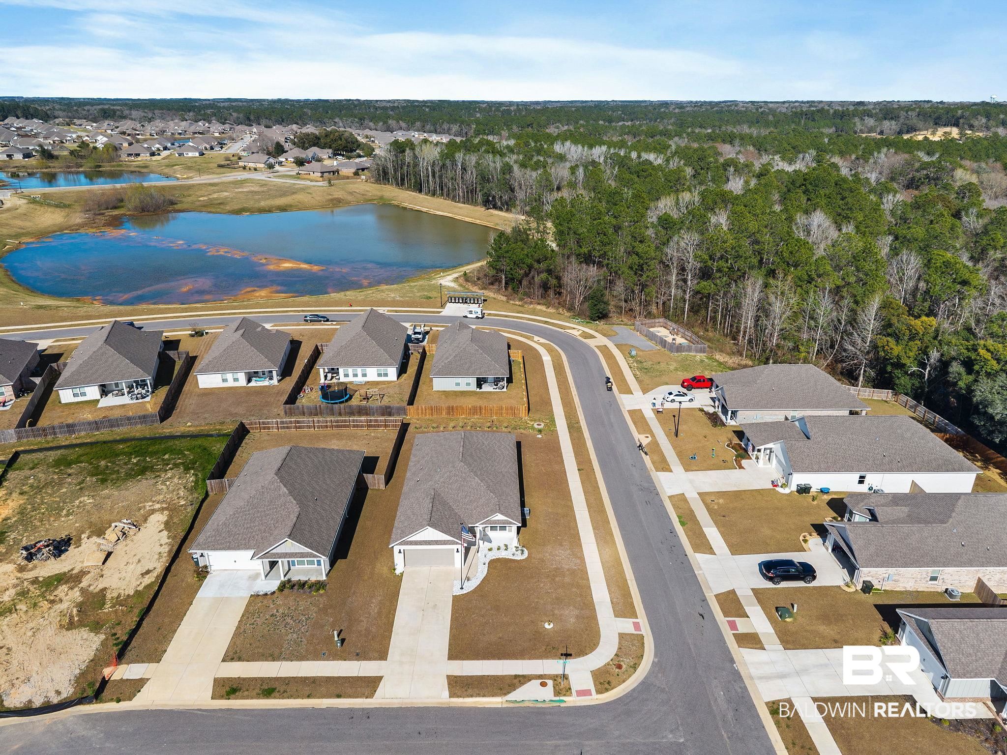 12919 Torrent Road Fairhope, AL 36532 - Photo 58 of 74 Aerial perspective of suburban area featuring a large body of water