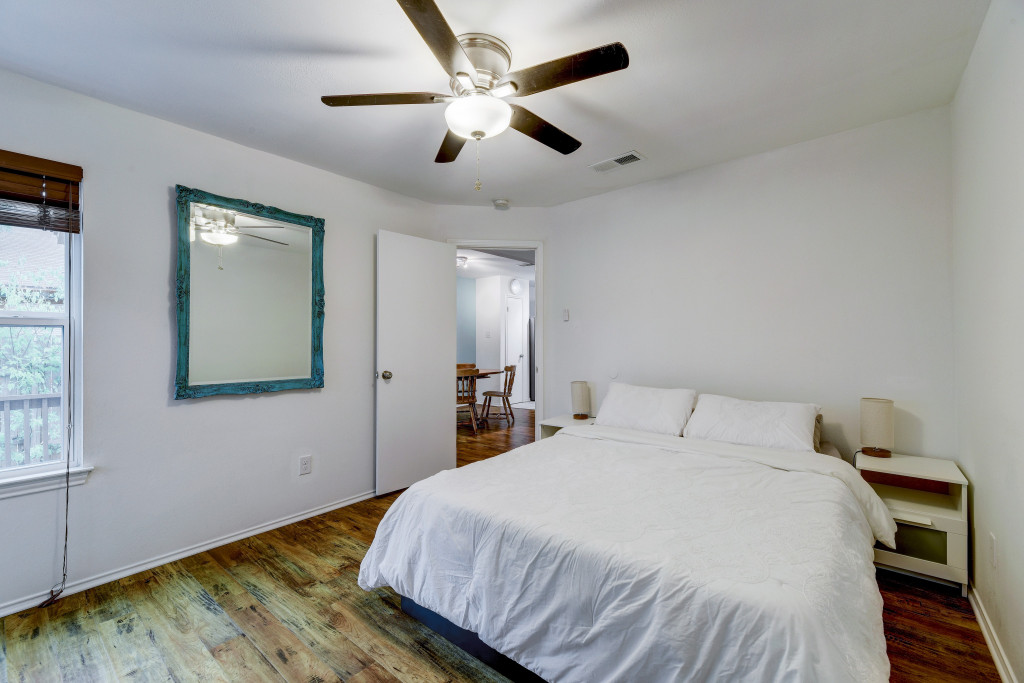 6002 Baton Rouge Drive Austin, TX 78727 - Photo 13 of 20 Bedroom featuring wood-finish flooring, a ceiling fan with integrated lighting, and a white interior door