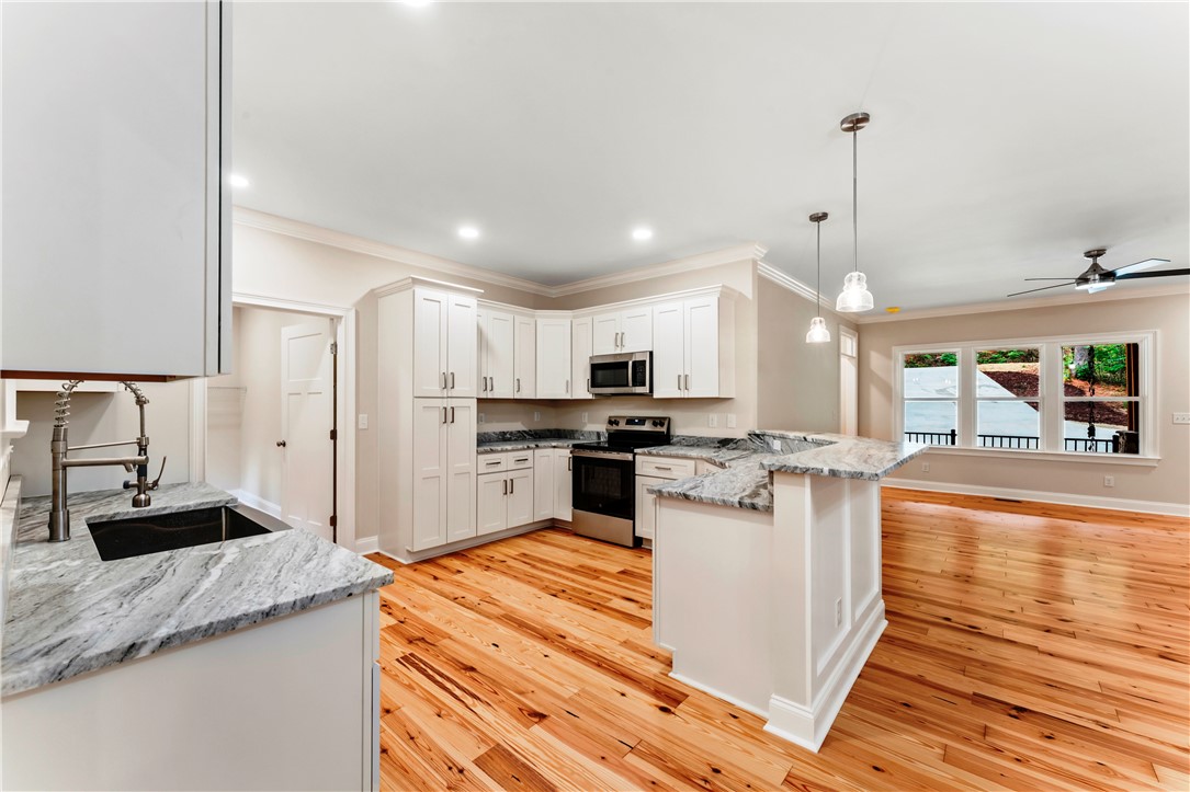 110 Gabriel Way Pickens, SC 29671 - Photo 7 of 48 A well-appointed kitchen showcasing durable hardwood flooring and generous counter space.