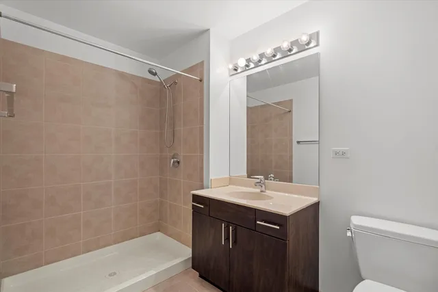 a utility room with wooden floor washer and dryer