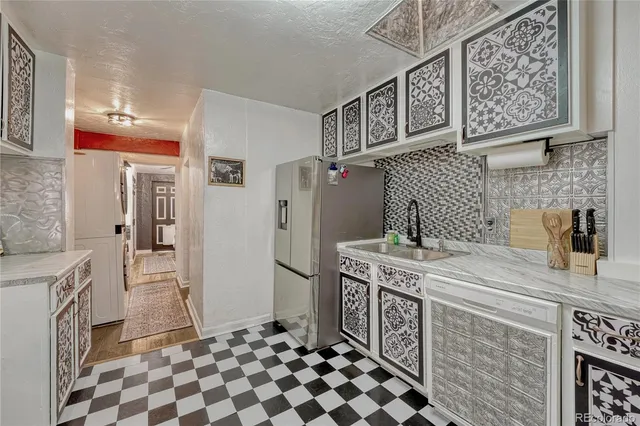 a kitchen with stainless steel appliances granite countertop a refrigerator and a stove