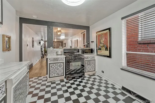 a kitchen with stainless steel appliances a stove a sink and a refrigerator
