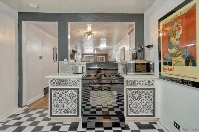 a kitchen with a stove a refrigerator and wooden cabinets