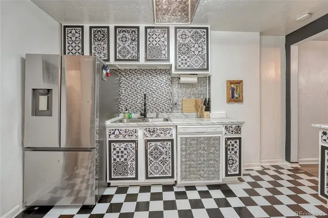 a kitchen with a cabinets and a refrigerator