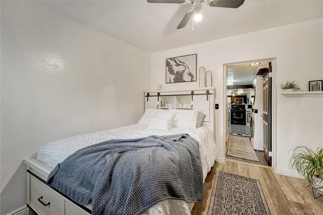 a bedroom with a bed and painting on the wall