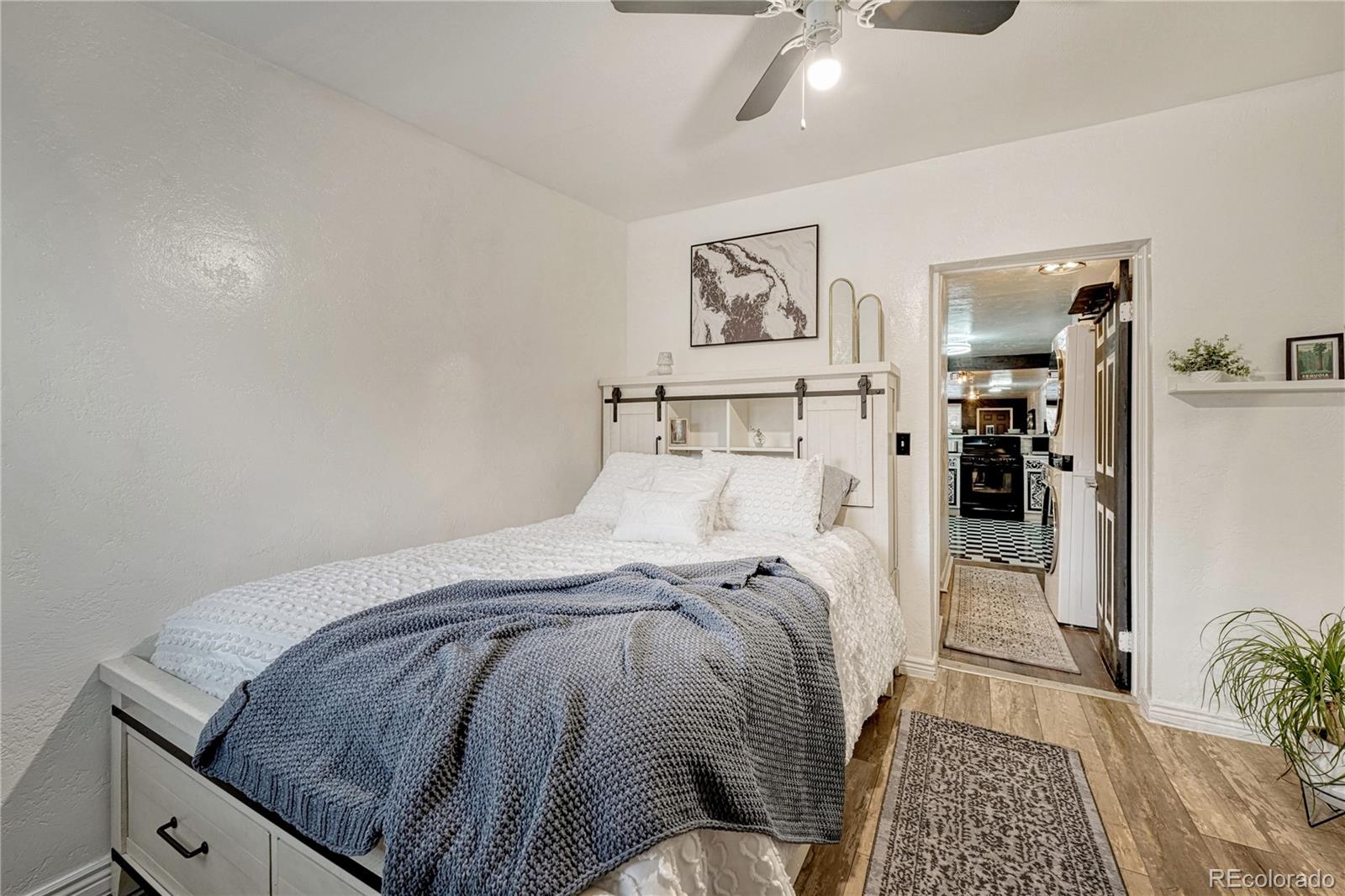 1026 Inca Street Denver, CO 80204 - Photo 21 of 27 a bedroom with a bed and painting on the wall