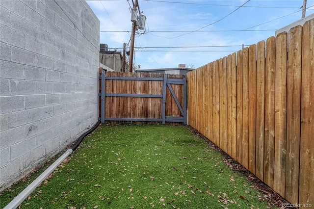 a view of a backyard with wooden fence