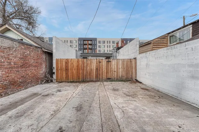 a view of an empty room with a brick wall