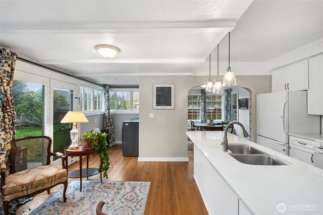 a living room with furniture or chandelier and a wooden floor