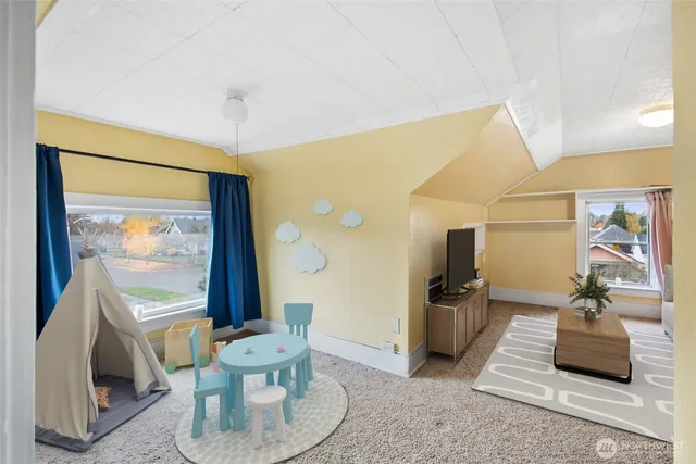 a living room with furniture and large window