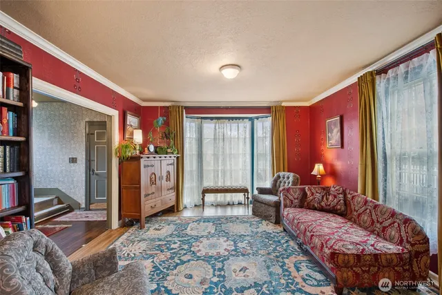 a bedroom with furniture and large window