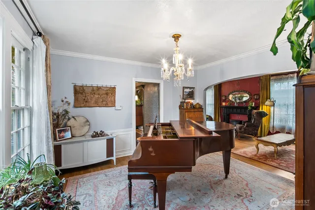 a living room with furniture and a chandelier