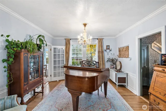 a living room with furniture and a chandelier